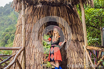 A female tourist dressed in the traditional dress of the inhabitants of the Vietnamese mountains, the Hmong. Woman in Stock Photo