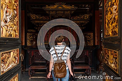Female tourist enters historical Chinese building Stock Photo