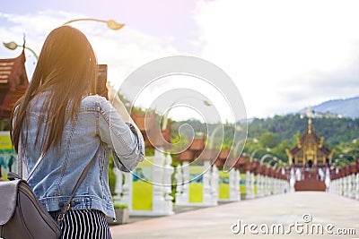 Female tourist taking picture of Buddhist temple in with mobile smart phone Editorial Stock Photo