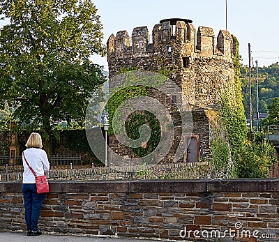 Female Tourists Views the Rheingautaunuskreis Fotification on the banks of the Rhine at Lorch. Editorial Stock Photo