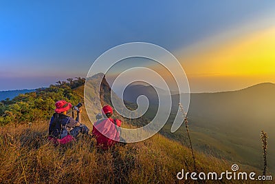 2 female tourists watching the sunset in the mountains Editorial Stock Photo