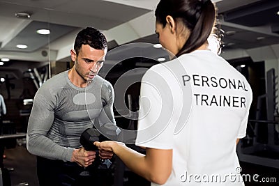 Female trainer doing workout with her client Stock Photo