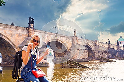 Female traveler enjoys views of the Charles Bridge in Prague Stock Photo