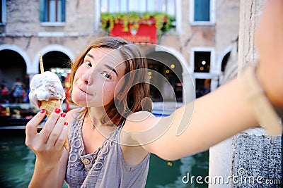 Female traveler making selfie photo with traditional italian ice cream in Venice Stock Photo