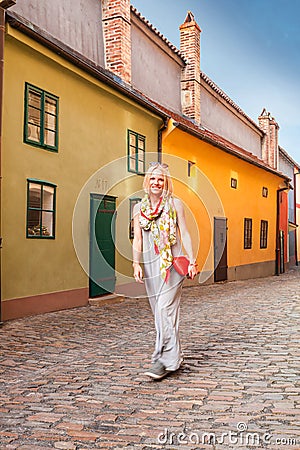 Female traveler walks around Golden Lane, Prague, Czech Republic. Stock Photo