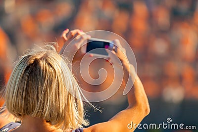 Female traveller make a photo of Dubrovnik to the phone. Stock Photo