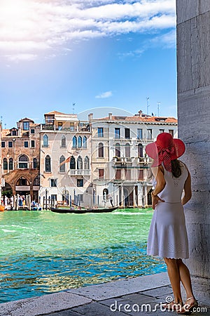 Woman enjoys the view to the architecture of the Canal Grande in Venice, Italy Stock Photo