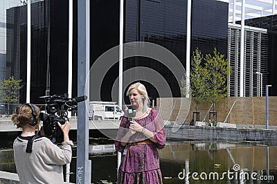 FEMALE TV REPORTER AND PHOTOJOURNALIST Editorial Stock Photo