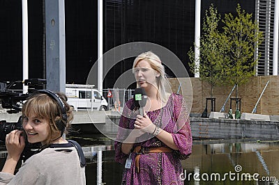 FEMALE TV REPORTER AND PHOTOJOURNALIST Editorial Stock Photo