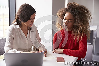 Female University Student Working One To One With Tutor Stock Photo