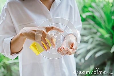 Female using alcohol antiseptic gel to cleaning hand Stock Photo