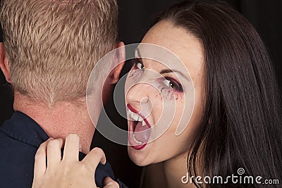 Female vampire bite mans neck fangs Stock Photo