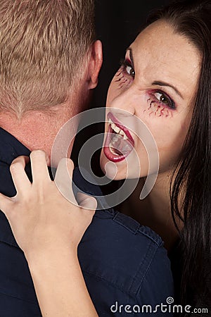 Female vampire bite mans neck look Stock Photo