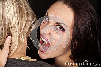 Female vampire bite womans neck looking Stock Photo