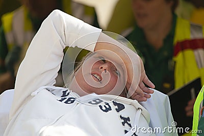 Female victim in pain on a stretcher Editorial Stock Photo