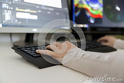 Female video editor works with footage on her personal computer, she works in creative office studio. Video editing Stock Photo