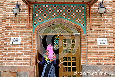 Female Visitor Entering the Prayer Room of the Mosque with Hair Covering Editorial Stock Photo