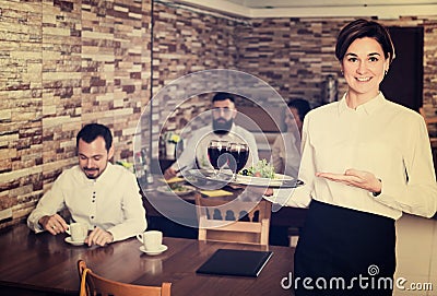 Female waiter showing country restaurant Stock Photo