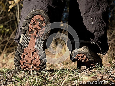 Female walking in high trekking boots on autumn path Stock Photo