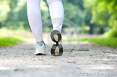 Female walking in running shoes outdoors Stock Photo