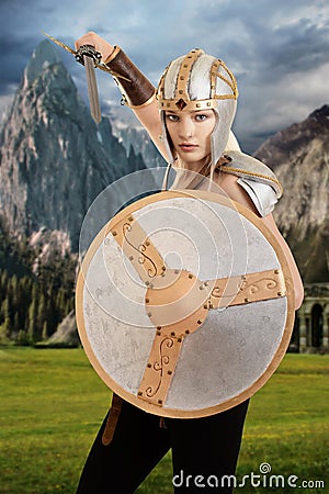 Female warrior attacking with shield and sword Stock Photo