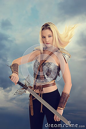 Female warrior with sword and hair blowing in wind Stock Photo