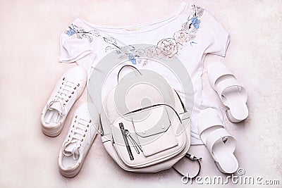 Female white backpack with shoes and a T-shirt Stock Photo