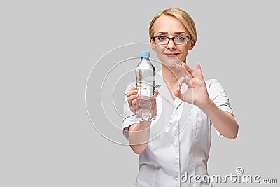 female woman nutritionist or dietician doctor healthy lifestyle concept - holding bottle of water Stock Photo