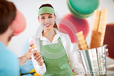 Female worker in confectionery giving ice cream to customer Stock Photo