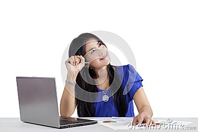 Female worker daydreaming while working Stock Photo