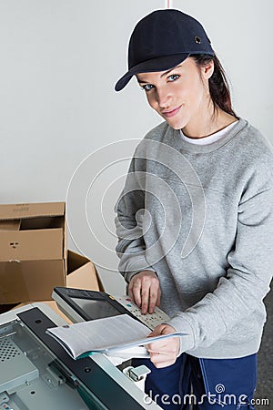 Female worker photocopying book Stock Photo