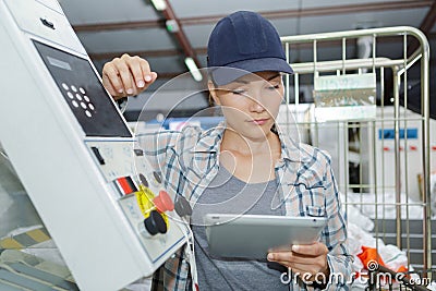 Female worker using digital tablet in manufacturing industry Stock Photo