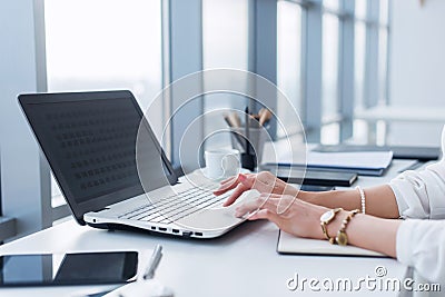 Female worker using laptop in office, working with new project. Woman blogging at home as a freelancer. Stock Photo