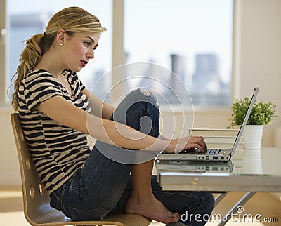 Female working on computer at home Stock Photo