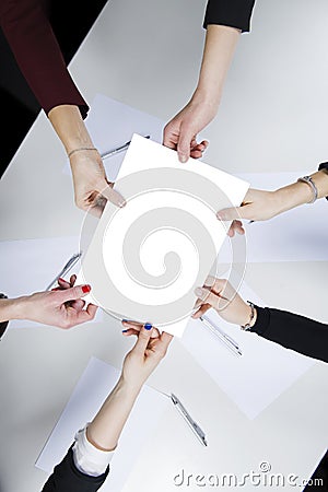 A female working group holds a blank sheet in her hand Stock Photo