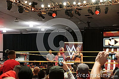 Female wrestler Becky Lynch talks on mic with NXT star Sasha Banks also in ring Editorial Stock Photo