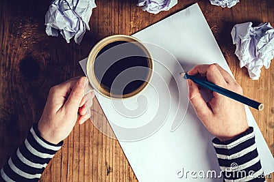 Female writer drinking cup of coffee Stock Photo