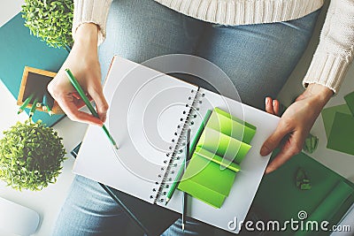 Female writing in spiral notepad closeup Stock Photo