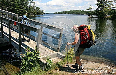 Females Backpacking Across Bridge Stock Photo