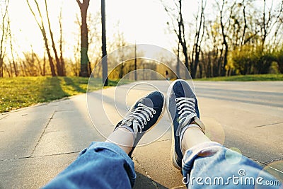 Females legs with Sneaker shoes on the ground Stock Photo