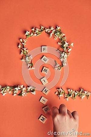 Femenism on wooden alphabet, symbolizing woman gender and equality Stock Photo