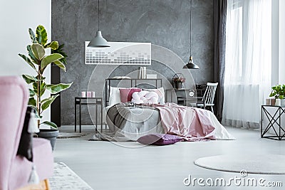 Feminine bedroom with pink sheets Stock Photo