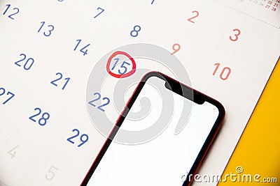 Feminine calendar with reminder ovulation in graph and smartphone. Tracking the menstrual cycle and ovulation concept Stock Photo