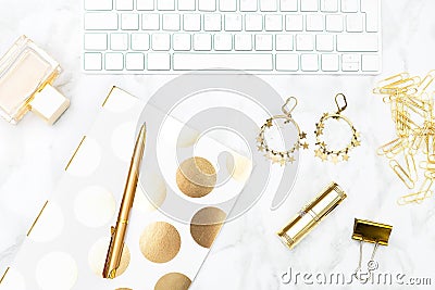 A feminine desk with gold objects. Flat lay Stock Photo