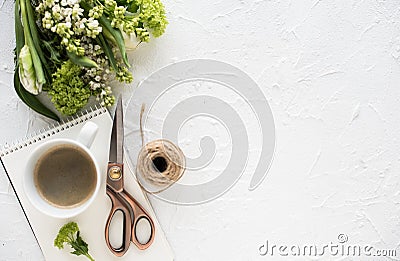 Feminine flatlay with flowers and ccoffee on white tabletop Stock Photo