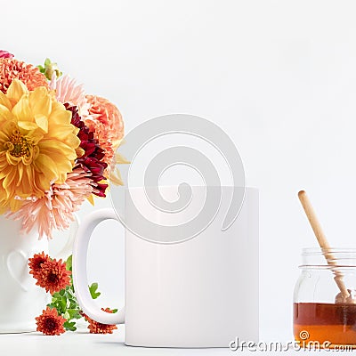 Feminine floral White Mug Mockup, white coffee mug next to Dahlias and honey pot. Perfect for businesses selling mug mockups Stock Photo