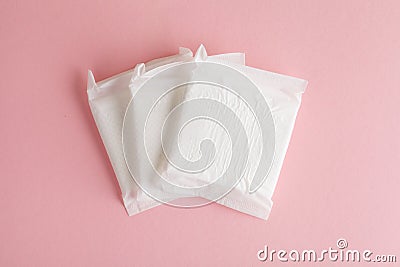 Feminine hygiene and protection, sanitary pads on pastel pink background, top view, flat layout Stock Photo
