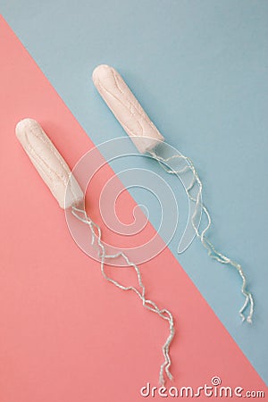 Feminine hygiene tampon on a pink background. The concept of feminine hygiene during menstruation. Flat lay, top view Stock Photo