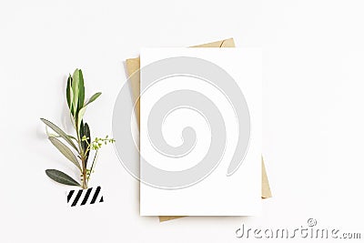 Feminine stationery, desktop mock-up scene. Blank greeting card, craft envelope, washi tape and with olive branch.White Stock Photo