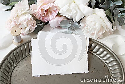 Feminine wedding or birthday table composition with floral bouquet. White and pink peonies flowers, eucalyptus, old Stock Photo